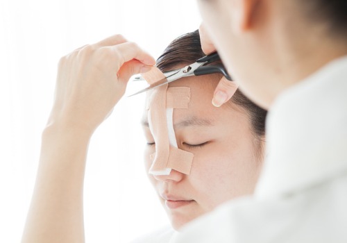 doctor-to-taping-a-patients-nose-picture-id485397834 doctor-to-taping-a-patients-nose-picture-id485397834